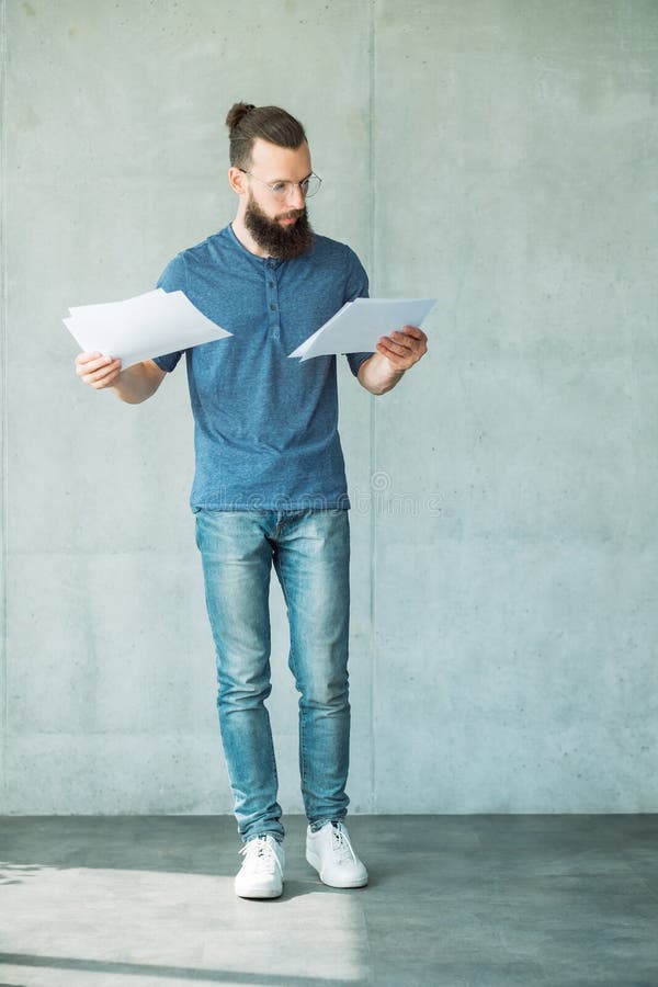 Den fokuserade mannen läste information om affärsdokument royaltyfri bild Den fokuserade mannen läste information om affärsdokument royaltyfri bild