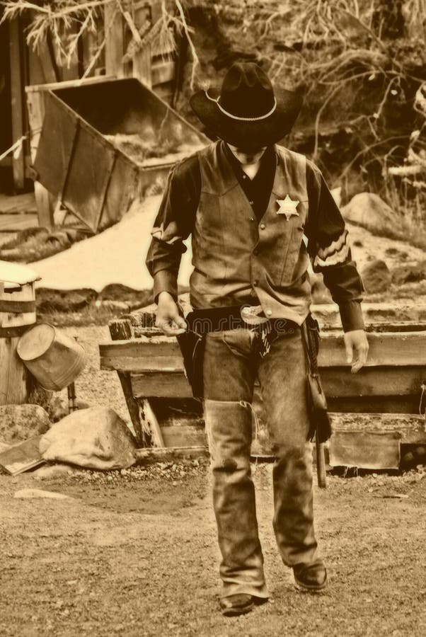 Old west Marshall walks alone to protect his town. Old west Marshall walks alone to protect his town