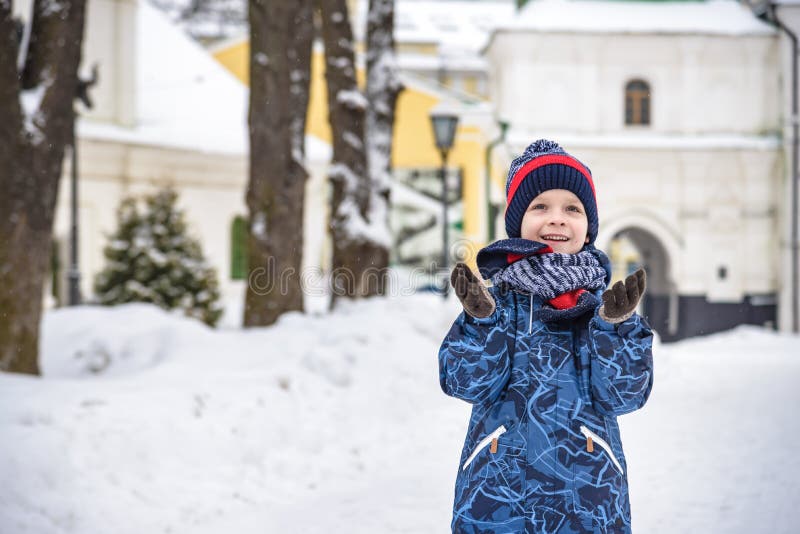 Den lilla pojken går i parken Barn som går på en promenad efter skolan med en skolväska på vintern Barn som är aktiva utomhus arkivfoton Den lilla pojken går i parken Barn som går på en promenad efter skolan med en skolväska på vintern Barn som är aktiva utomhus arkivfoton