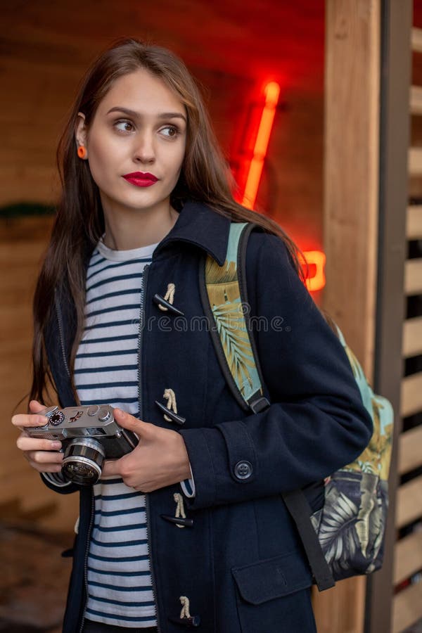 Den lyckliga unga hipsterkvinnan rymmer den retro fotokameran arkivbilder Den lyckliga unga hipsterkvinnan rymmer den retro fotokameran arkivbilder