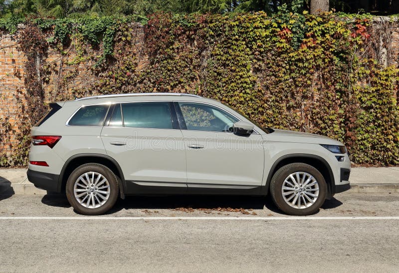 Udine, Italy. October 6, 2022. New Skoda Kodiaq, crossover suv of the czech automaker. Brick wall with ivy on background. Udine, Italy. October 6, 2022. New Skoda Kodiaq, crossover suv of the czech automaker. Brick wall with ivy on background.