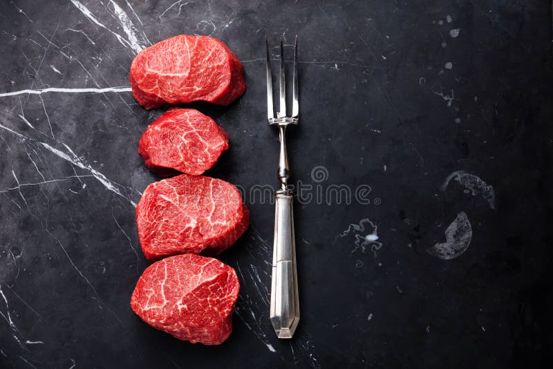 Den rå marmorerade mignonen och kött för köttbifffilet dela sig royaltyfri bild Den rå marmorerade mignonen och kött för köttbifffilet dela sig royaltyfri bild
