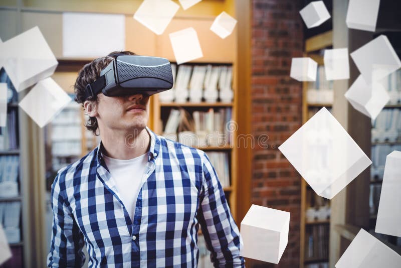 Digitally generated grey cubes floating against male student using virtual reality headset. Digitally generated grey cubes floating against male student using virtual reality headset