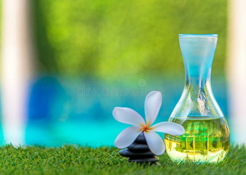 Den thailändska Spa massagen med vaggar brunnsorten, och aromolja med Plumeria blommar nära simbassäng arkivbild Den thailändska Spa massagen med vaggar brunnsorten, och aromolja med Plumeria blommar nära simbassäng arkivbild