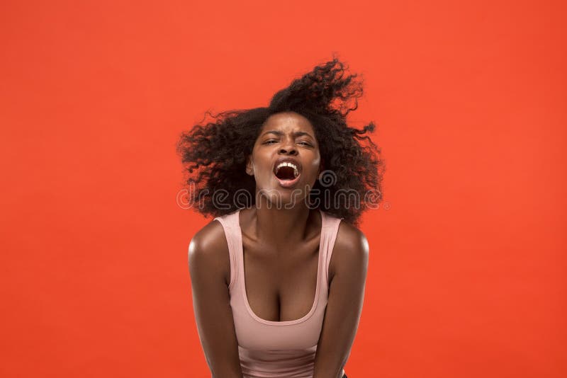 Screaming, hate, rage. Crying emotional angry afro woman screaming on red studio background. Emotional, young face. Female half-length portrait. Human emotions, facial expression concept. Trendy colors. Screaming, hate, rage. Crying emotional angry afro woman screaming on red studio background. Emotional, young face. Female half-length portrait. Human emotions, facial expression concept. Trendy colors