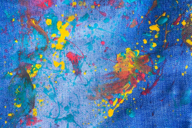 Denim or Colorful Paint on Blue Jeans Background. Drops of Color Paint