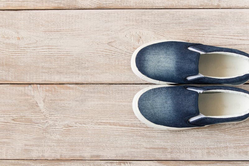 Denim Slip-on Shoes on Wooden Background. Top View Stock Photo - Image ...