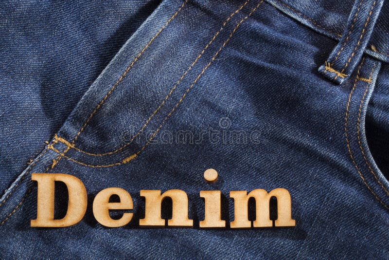 Word Jeans Made of Wooden Letters on Blue Trouser Fabric Stock Photo