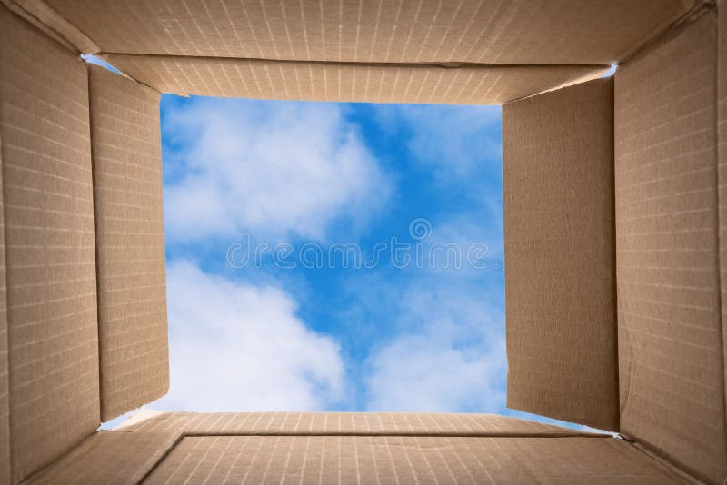 Think Outside the Box. Conceptual Image about Creative thinking consisting of a photo of the inside of an Open Cardboard Box with a Blue Sky with Clouds in Background. Think Outside the Box. Conceptual Image about Creative thinking consisting of a photo of the inside of an Open Cardboard Box with a Blue Sky with Clouds in Background