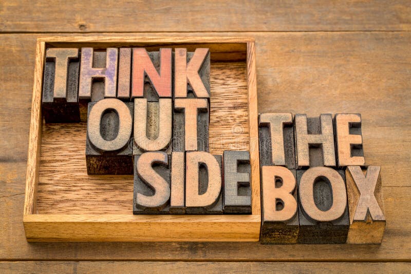 Think outside the box concept- motivational phrase in vintage letterpress wood type against rustic wood. Think outside the box concept- motivational phrase in vintage letterpress wood type against rustic wood