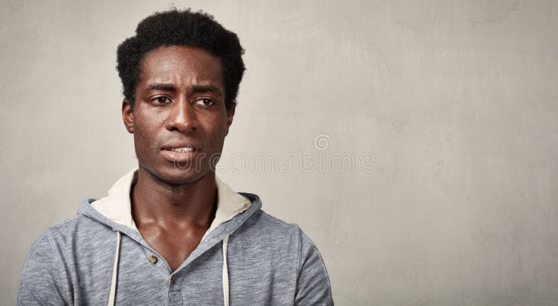 Thinking african american sad man gray wall background. Thinking african american sad man gray wall background