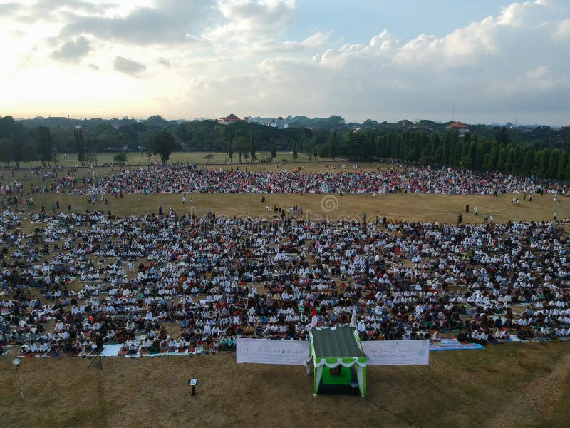 DENPASAR, BALI/INDONESIA-JUNE 05 2019: The view from the air of the Eid al-Fitr prayer in 2019 at Puputan Renon field. Eid prayers stock image DENPASAR, BALI/INDONESIA-JUNE 05 2019: The view from the air of the Eid al-Fitr prayer in 2019 at Puputan Renon field. Eid prayers stock image