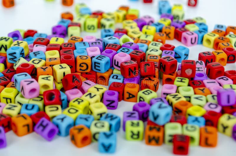 A dense arrangement of colorful transparent alphabet blocks forming a vibrant pattern symbolizing communication and imagination in royalty free stock photo