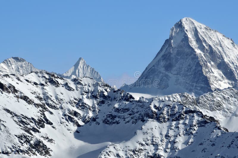 The Dent Blanche and the pointe de Zinal. The Dent Blanche (right) and the Pointe de Zinal (left). Giants in the Swiss Alps stock photos The Dent Blanche and the pointe de Zinal. The Dent Blanche (right) and the Pointe de Zinal (left). Giants in the Swiss Alps stock photos