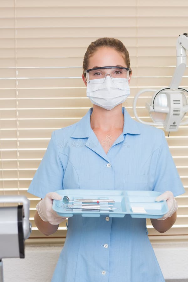 Dental Assistant in Blue Holding Tray of Tools Stock Photo Image of