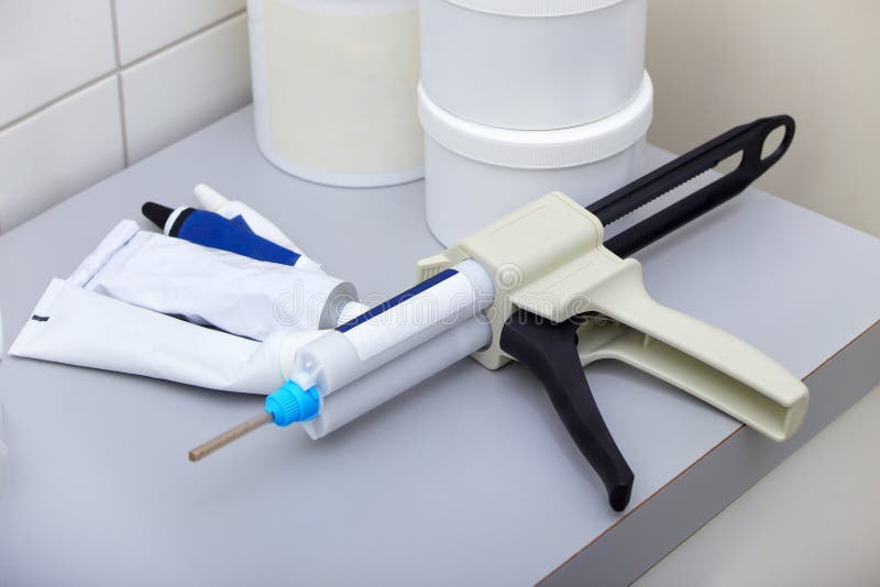 Dental dispensing gun stock image. Image of object, repair 63377535
