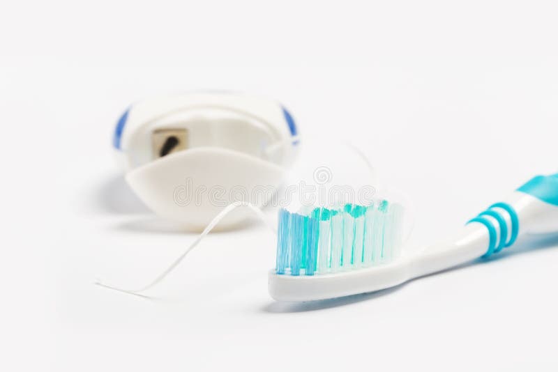 Dental Floss and Toothbrush Isolated on a White Background Stock Image