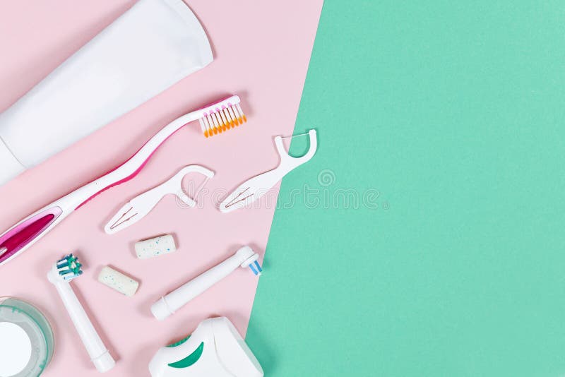 Dental hygiene care concept flat lay with toothbrush,  chewing gum, floss, toothpaste and electric toothbrush heads