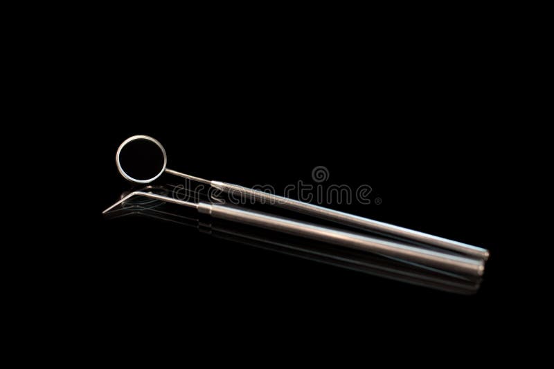 Dental Mirror and Dentist Probe. Image on Black Background Stock Photo