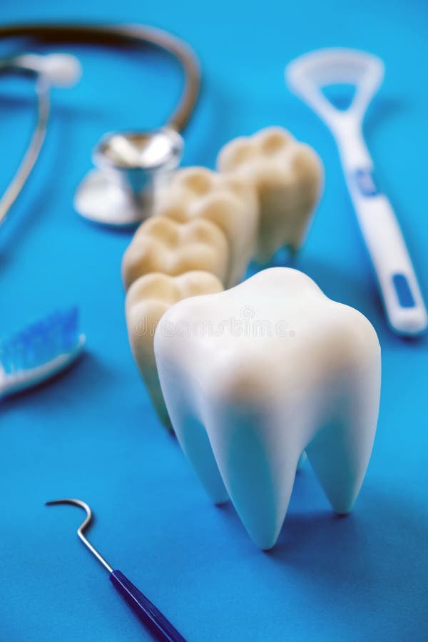 Dental Model and Dental Equipment on Blue Background Stock Image