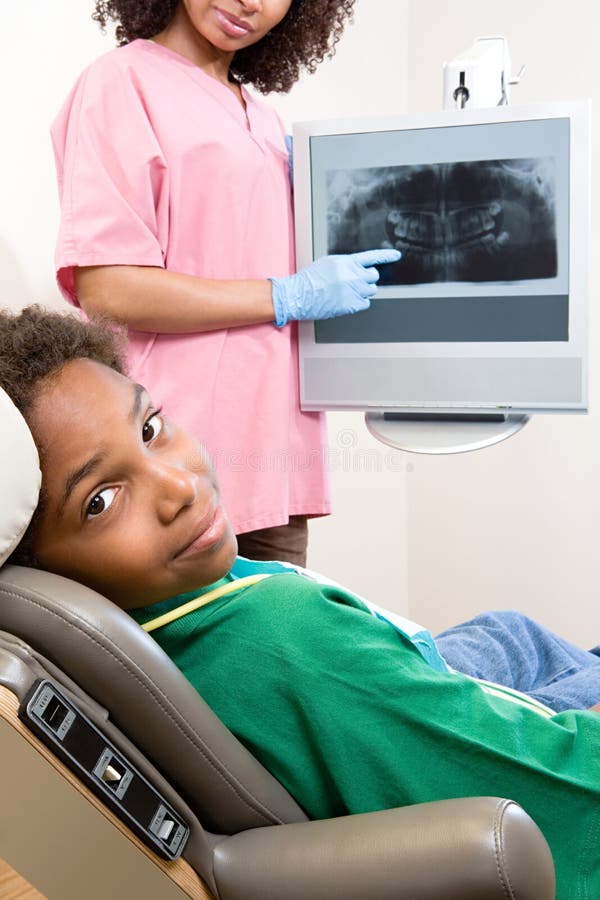 Dental nurse showing patient x ray stock images