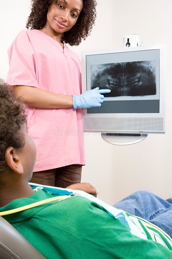 Dental nurse showing patient x ray royalty free stock photos