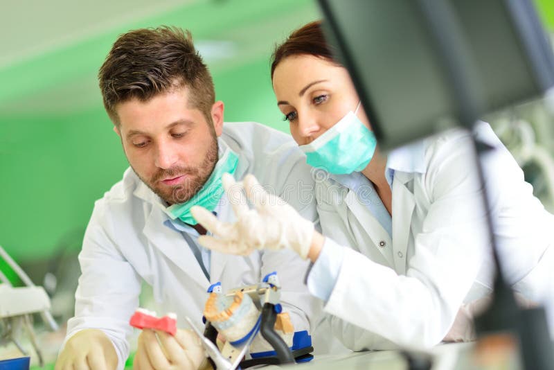 Dental Prosthesis, Dentures, Prosthetics Work. Prosthetics Hands while Working on the Denture