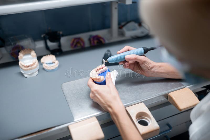 Dental Technician Constructing Prosthetic Denture for the Patient