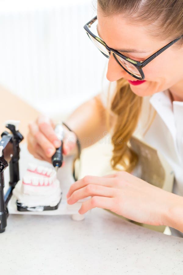 Technician Producing a Dental Prosthesis in a Laboratory or Stock Image Image of