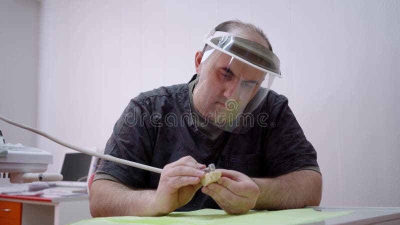 The dental technician makes a framework for implants. stock video footage