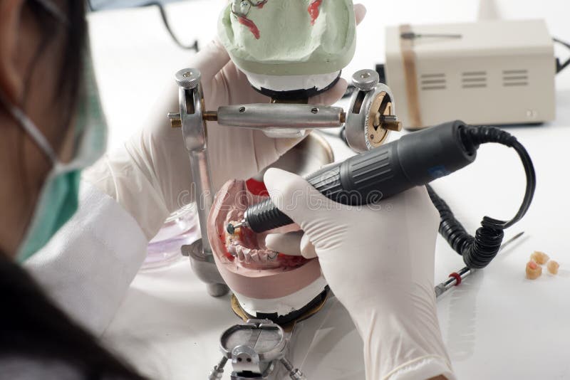 Dental technician working with articulator stock photos Dental technician working with articulator stock photos