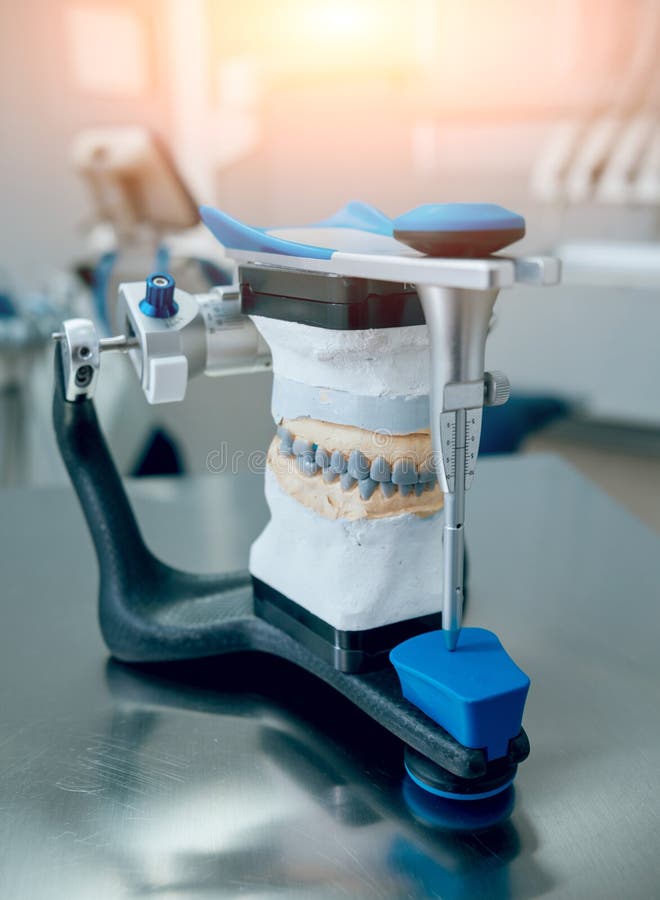 Dental Technician Working with Articulator in Dental Lab Stock Photo