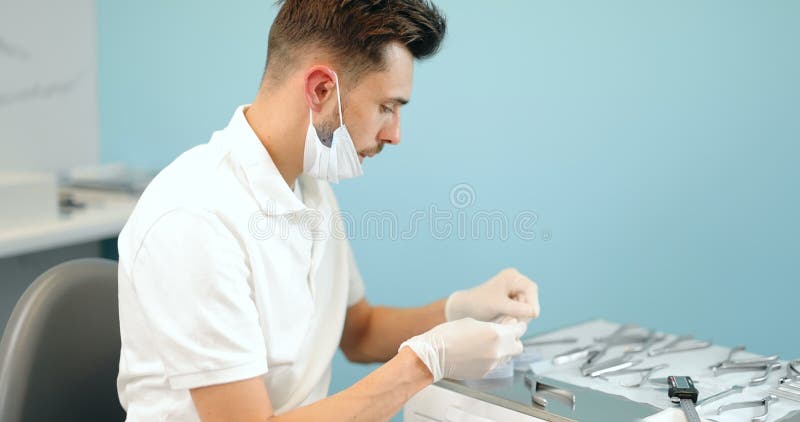 Dental technician working with a model of teeth and dental braces stock video