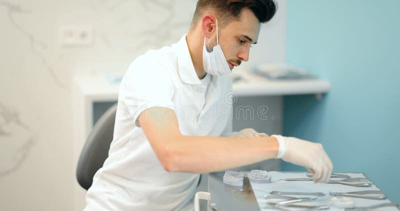 Dental technician working with a model of teeth and dental braces stock video