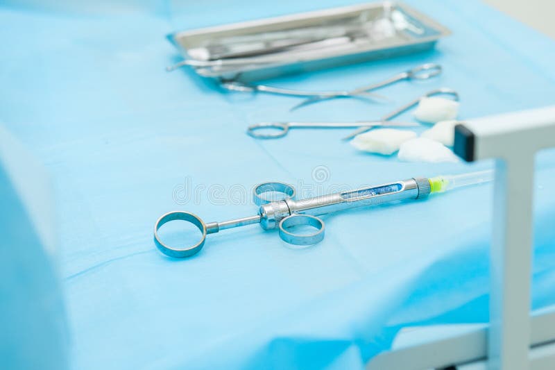 Dental Tools and Syringe at Dentist`s Surgery Table on the Background