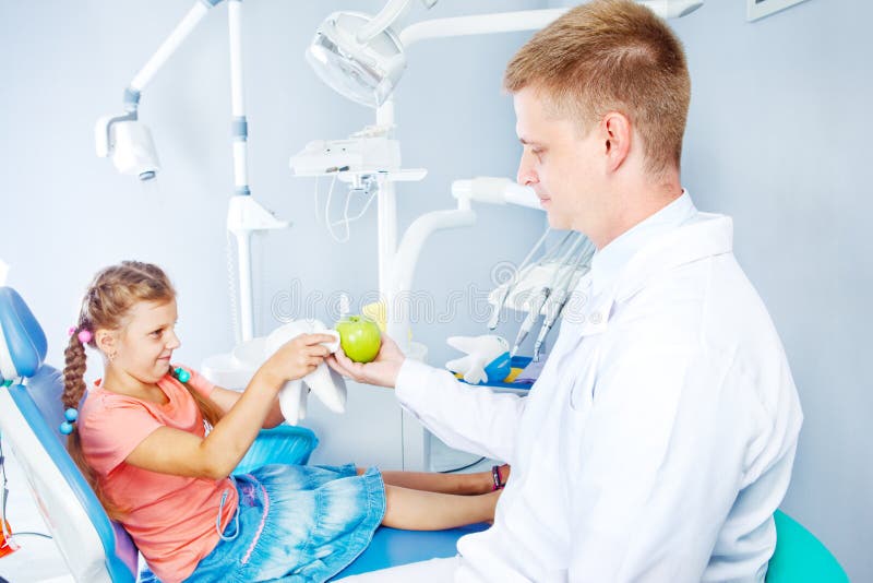 Dentist with an apple stock photo. Image of dentist, dental 25894442