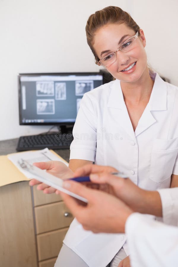 Dentist and Assistant Studying Xrays on Computer Stock Image Image