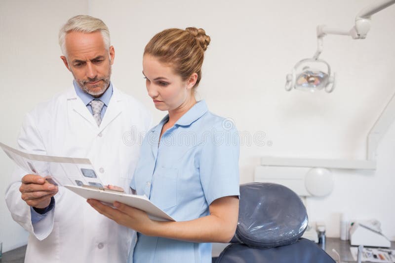 Dentist and Assistant in Exam Room with Woman Stock Photo Image of