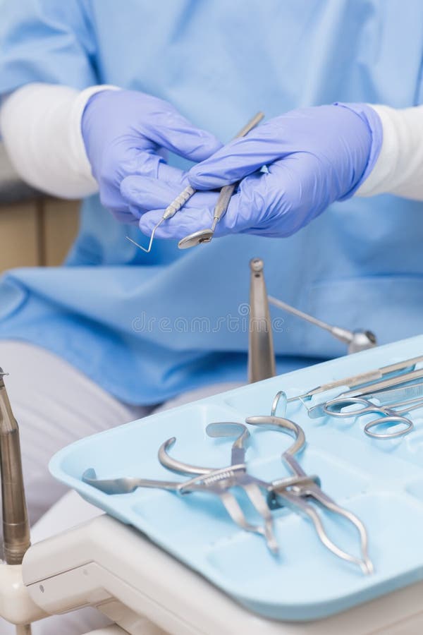 Dentist in Blue Scrubs Holding Dental Tools Stock Image Image of