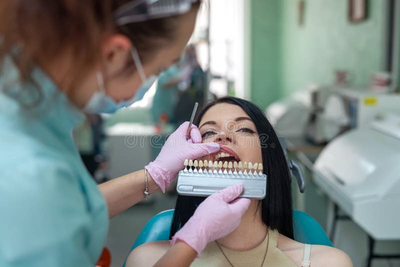 Dentist Comparing Patient S Tooth Color Sampler in Dentistry Stock