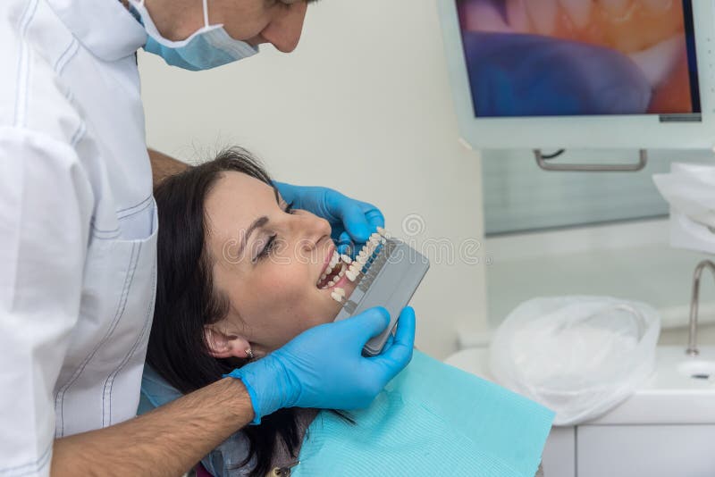 Dentist Comparing Patient Teeth with Crown Sampler Stock Image Image