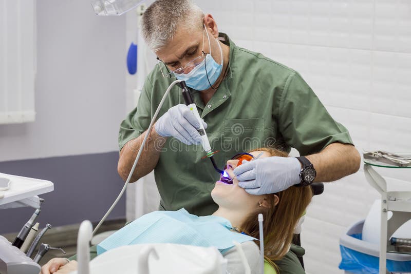 Dentist Examining Girl`s Teeth in Clinic. Dental Problem. Stock Image