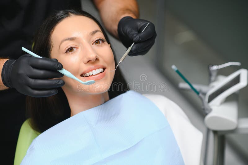 Dentist Examining a Patient S Teeth in the Dentist Stock Photo Image