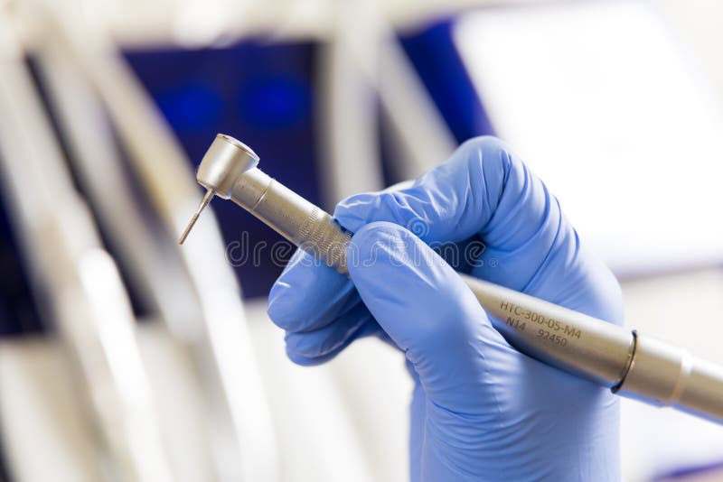 Dentist Hand with Drill Illustrates the Operation of the Dentist Dental