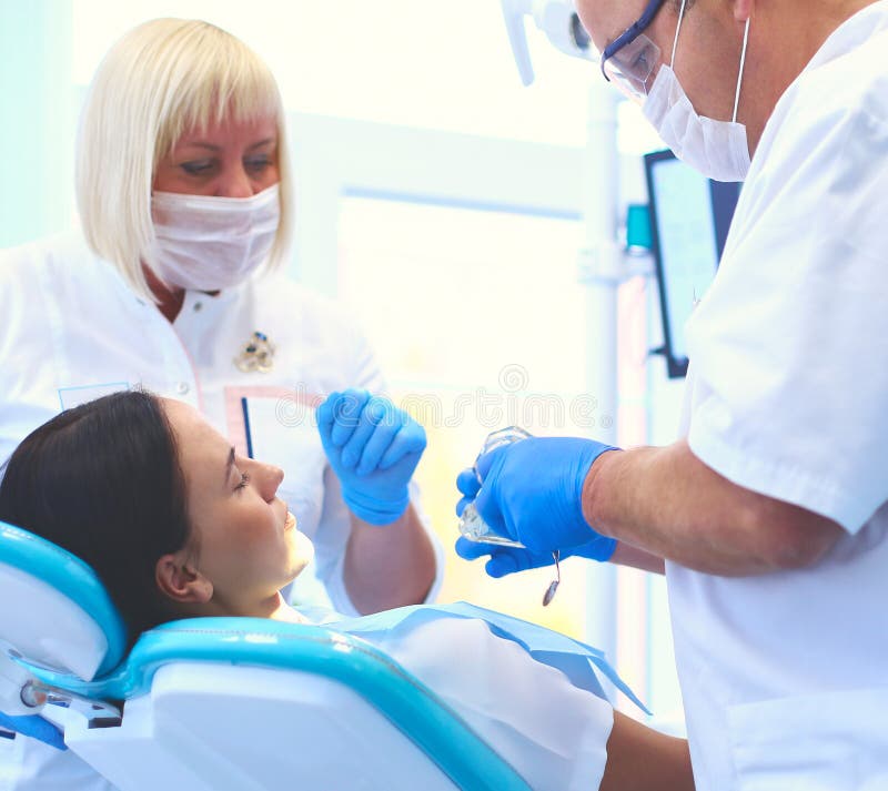 Dentist and His Assistant Carrying Out a Thorough Examination Stock