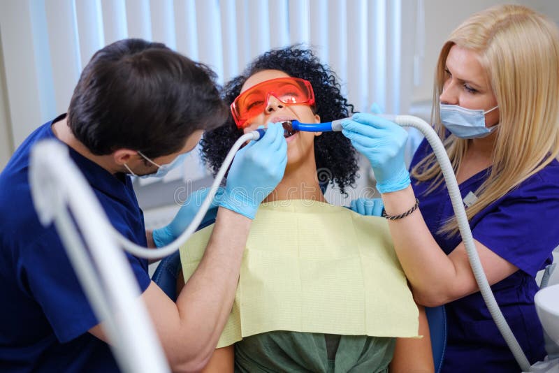 Dentist and his assitant working in private practice stock photography Dentist and his assitant working in private practice stock photography