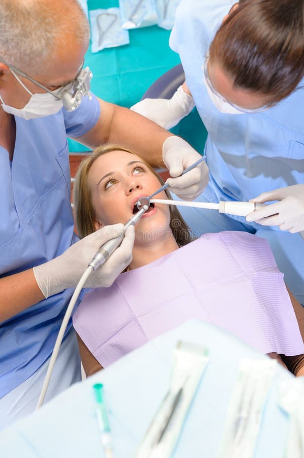 Dentist with Nurse Doing Procedure on Patient Stock Photo Image of