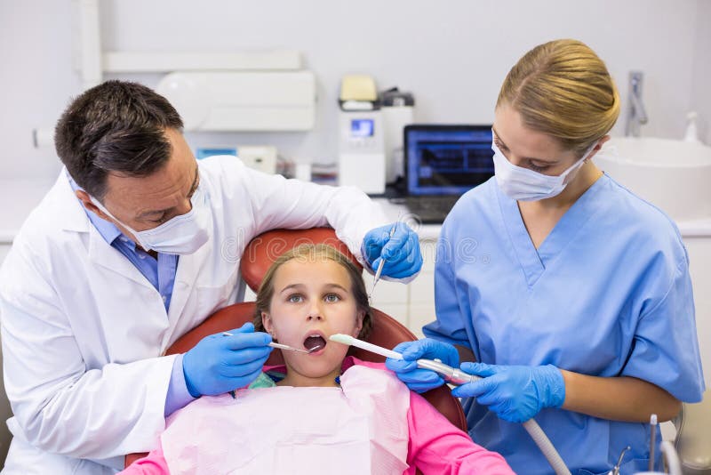 Dentist and Nurse Examining a Young Patient with Tools Stock Image Image of dental, female