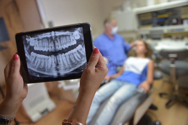 Dentist OfficeDigital Tablet with a Patients Xrays Stock Photo