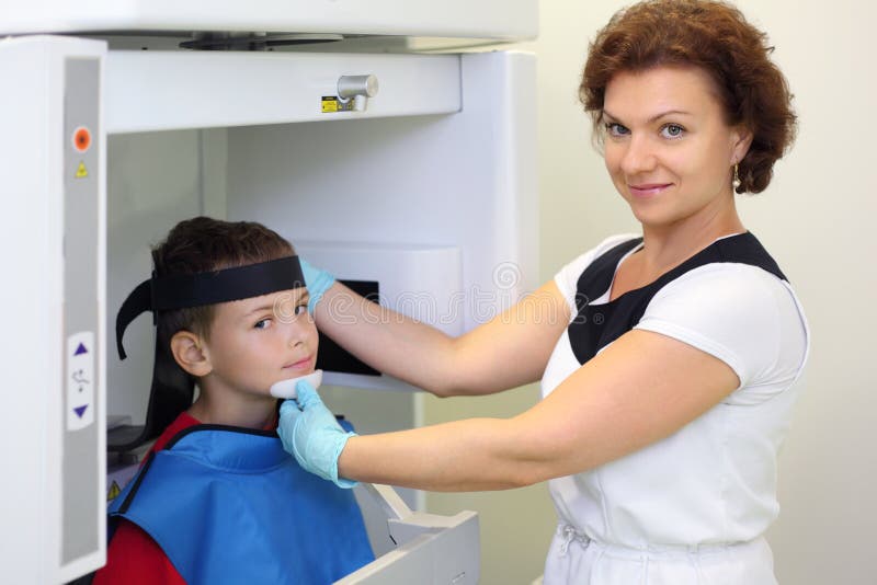 Dentist prepares boy wearing in protective lead royalty free stock image